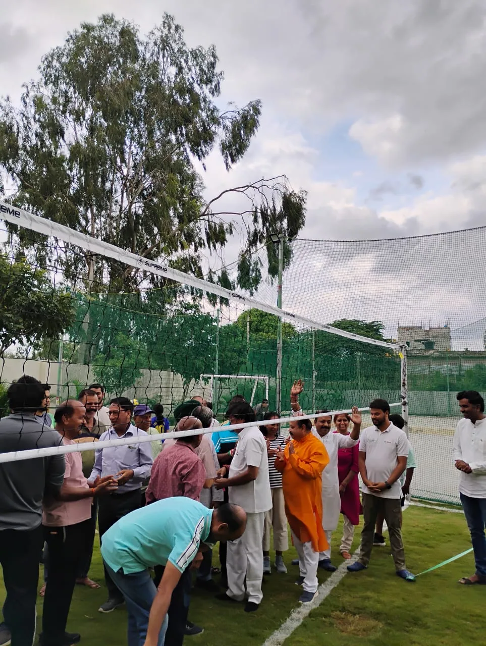 Neighbours celebrating together beside the new volleyball net
