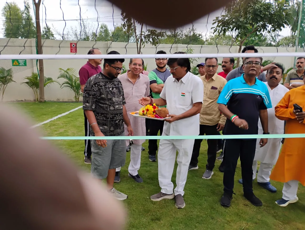 Residents gathered for the ceremonial opening of the volleyball court