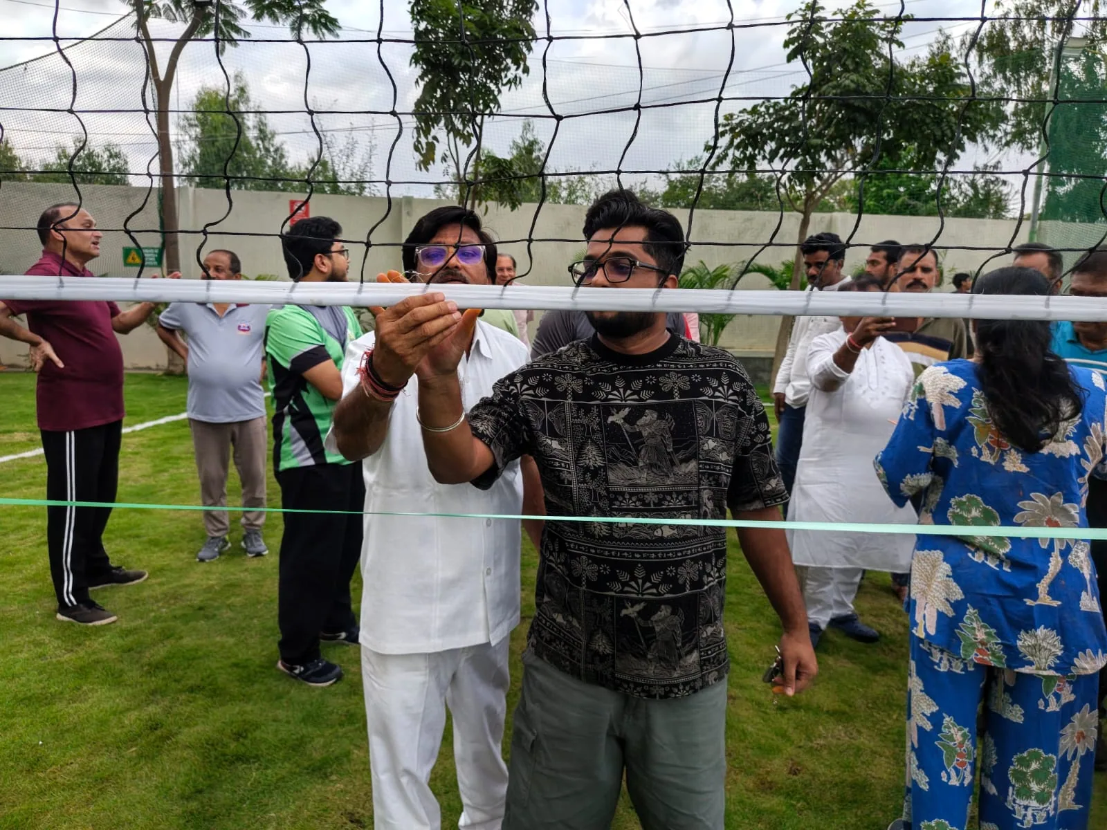 Residents preparing the volleyball net during the court inauguration