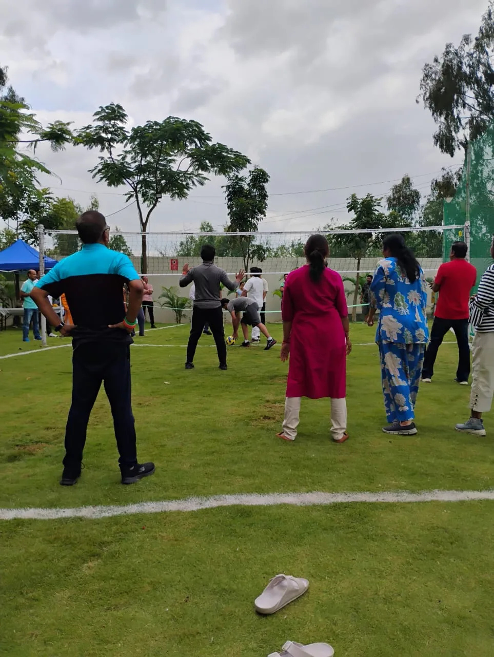 Residents playing the first community rally on the new volleyball court